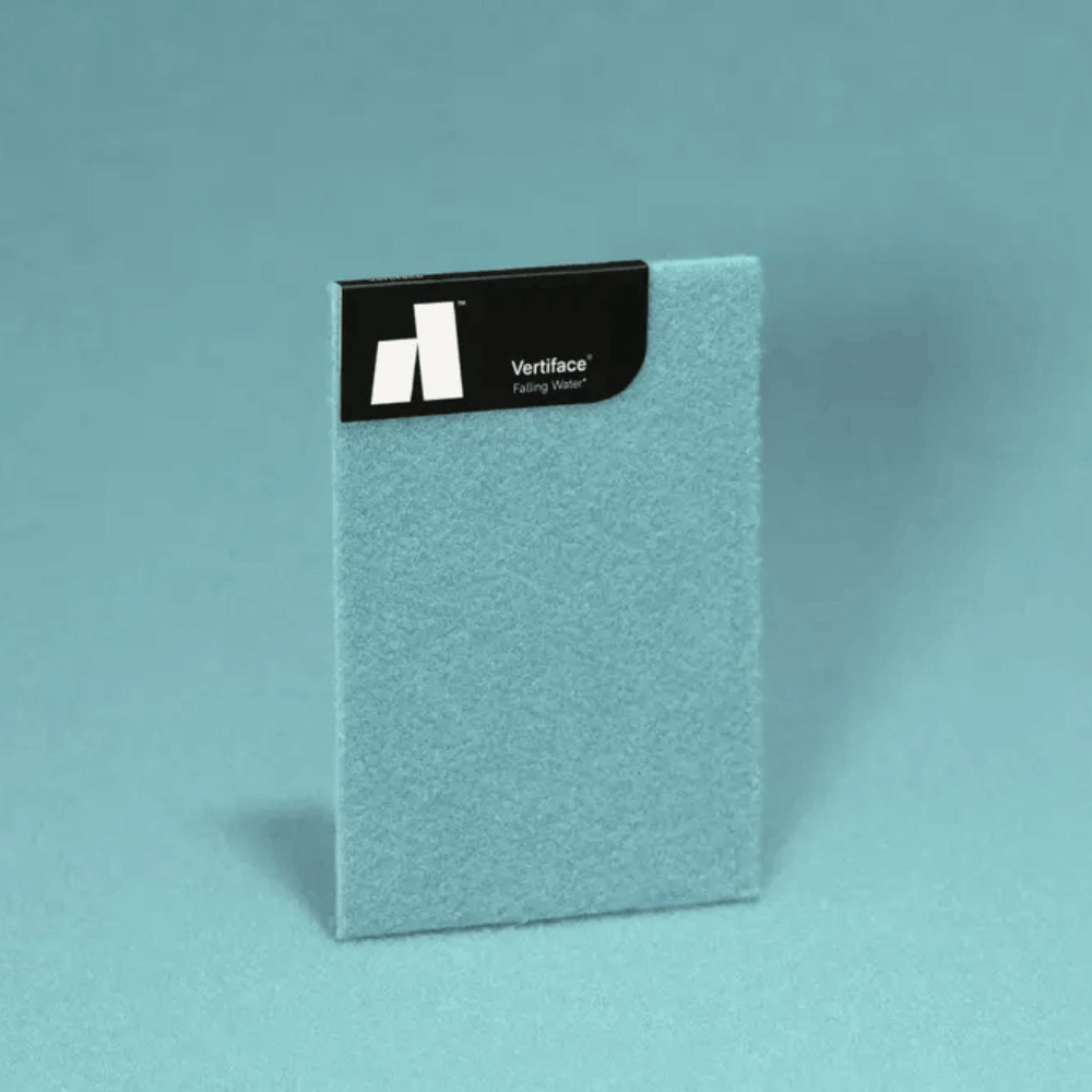 Sample of Vertiface® fabric wall covering in soft blue color, showcasing texture and branding for design inspiration.