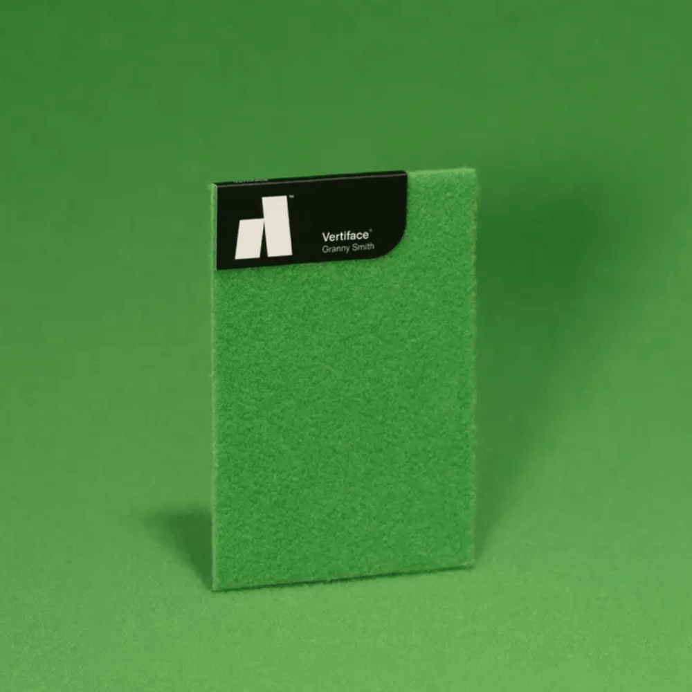Vertiface® acoustic panel sample in vibrant green color, showcasing its texture and branding.