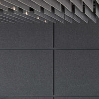 Dark textured wall featuring Autex Cube™ Acoustic Panels for superior sound absorption and modern interior design.