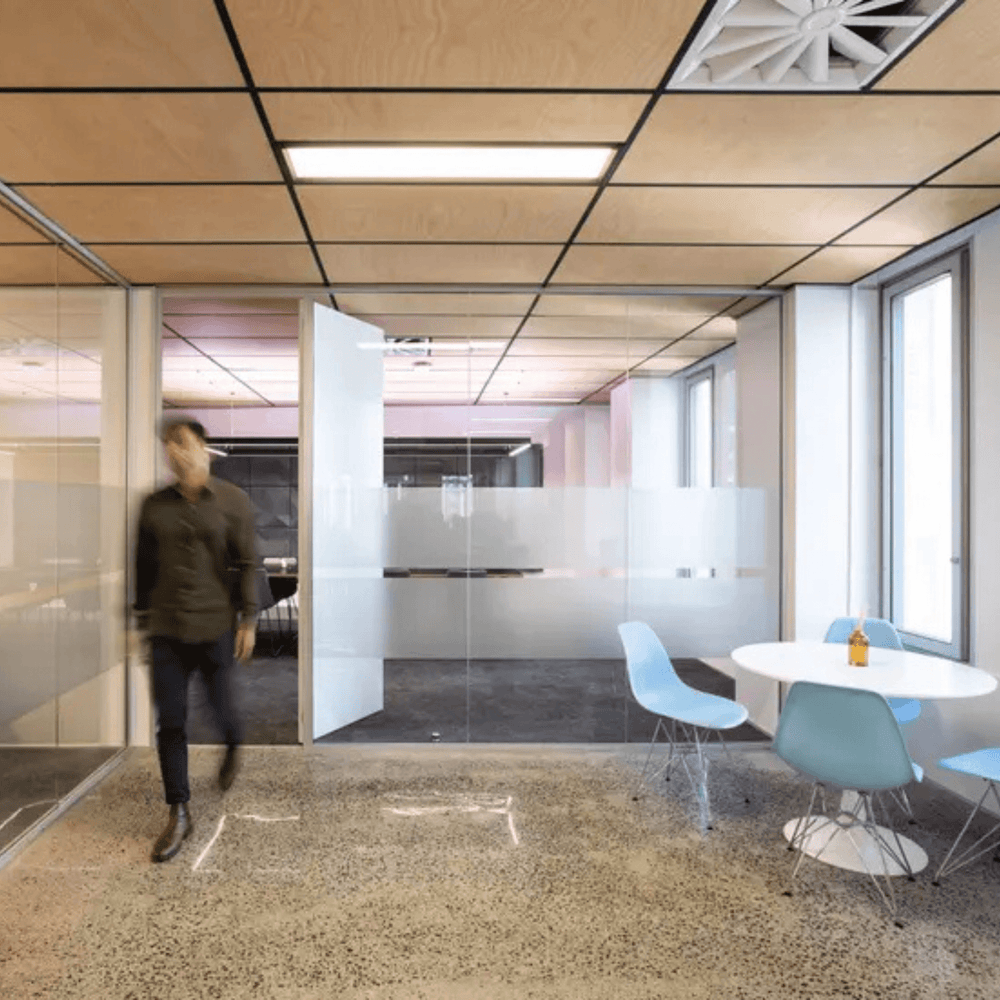 Modern office interior featuring Autex Acoustic Timber ceiling tiles and contemporary furniture.