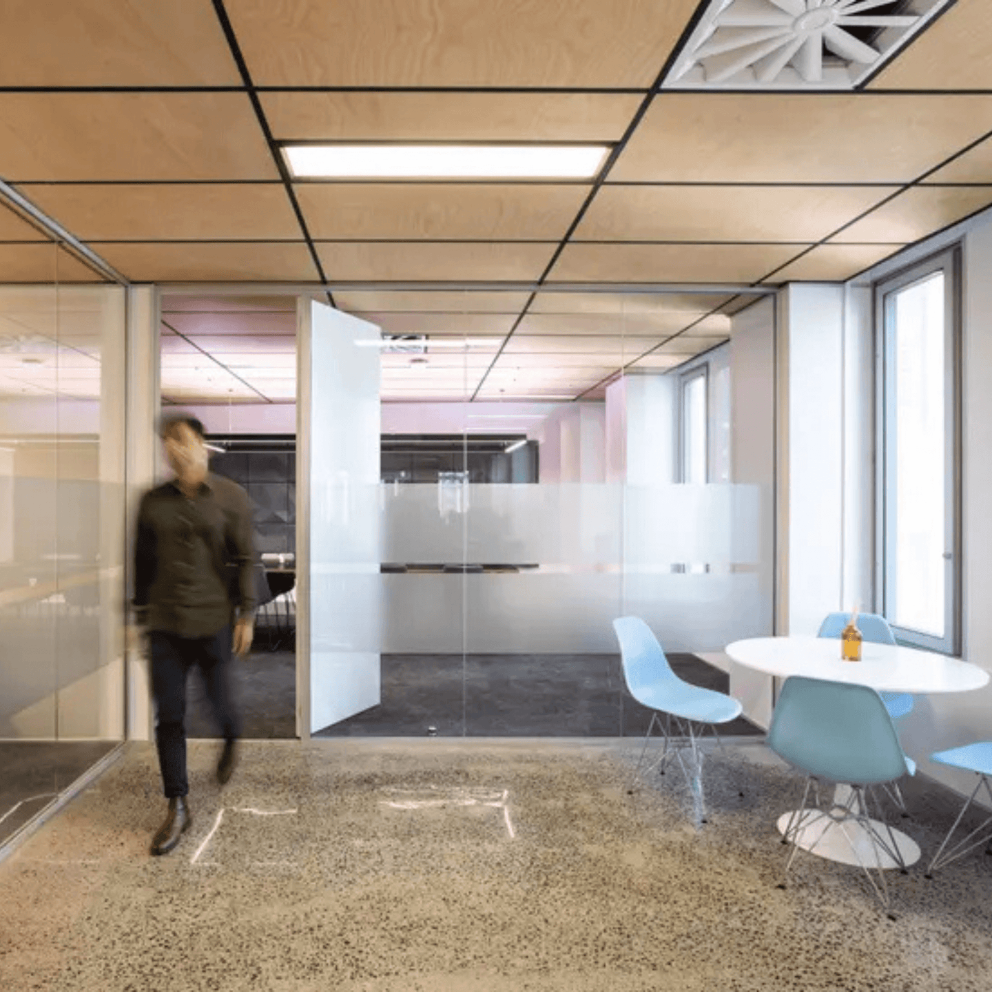 Modern office interior featuring Autex Acoustic Timber ceiling tiles and contemporary furniture.